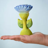 The Bumbu Toys Flama Spring Flower shown in an adult's hand. 