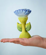 The Bumbu Toys Flama Spring Flower shown in an adult's hand. 