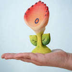 The Bumbu Toys Perla Spring Flower shown in and adult's hand.