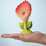 The Bumbu Toys Perla Spring Flower shown in and adult's hand.