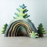 A Bumbu Toys Dragon's Cave surrounded by Bumbu trees and foliage. 