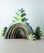 A Bumbu Toys Dragon's Cave surrounded by Bumbu trees and foliage. 