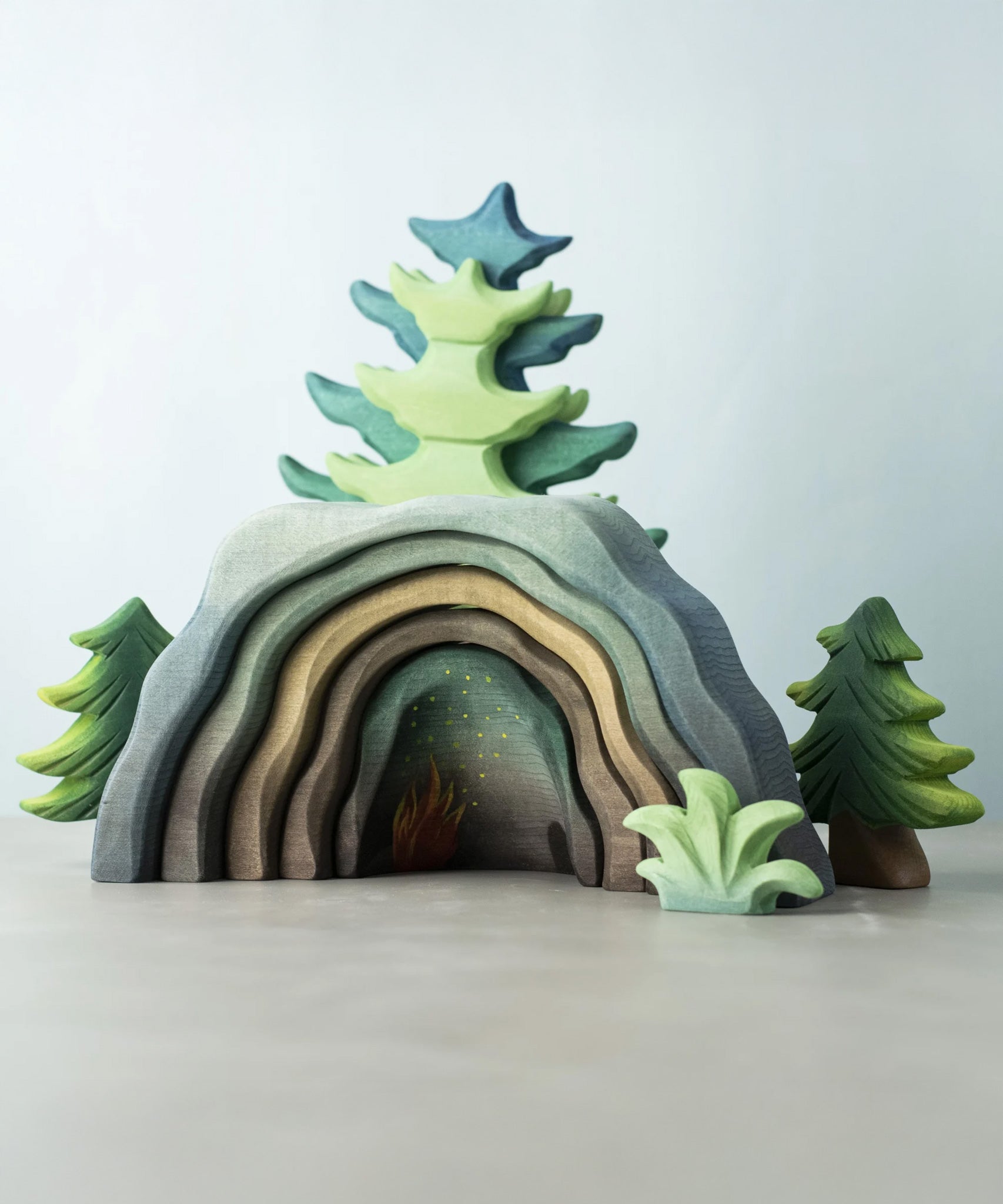 A Bumbu Toys Dragon's Cave surrounded by Bumbu trees and foliage. 