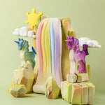 The Bumbu Toys Rainbow waterfall and Rainbow Rocks shown in a small world play scene alongside Bumbu unicorns. 
