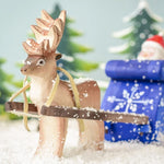 Bumbu Toys Reindeer placed at the front of a festive themed small world play scene. 