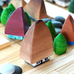 Bumbu Transylvania houses on a wooden table surrounded by Grapat mandala trees