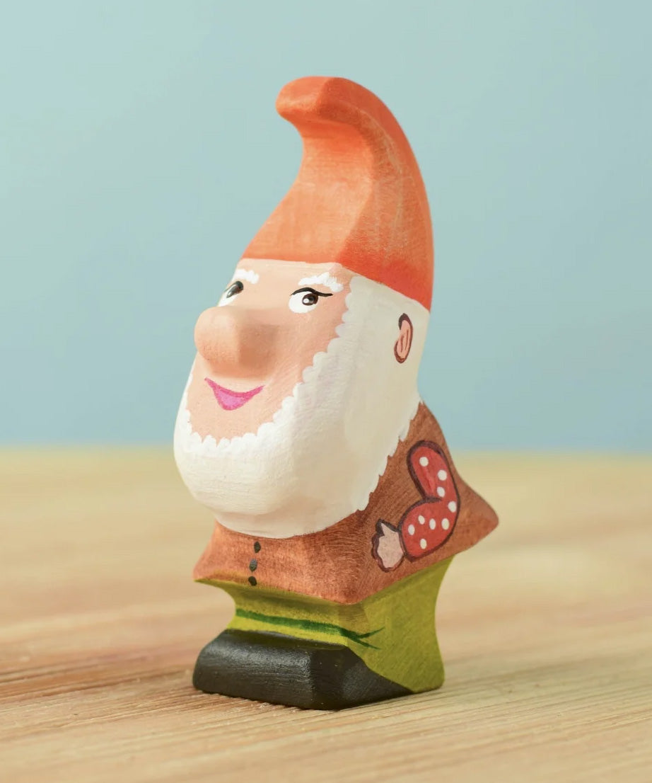 The Bumbu Toys Tumble Dwarf wooden figure has a white beard and a red coloured hat.