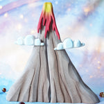 A Bumbu volcano with a wonder cloth in the background surrounded by glass marbles. 
