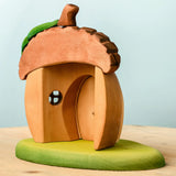 Back of Bumbu toys handcrafted wooden acorn house showing removable door and cut out window