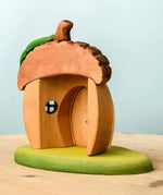 Back of Bumbu toys handcrafted wooden acorn house showing removable door and cut out window