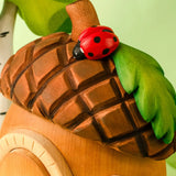 Bumbu toys handcrafted wooden acorn house showing roof detail with ladybird figure standing on top