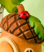 Bumbu toys handcrafted wooden acorn house showing roof detail with ladybird figure standing on top