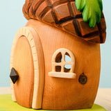 Side view of the Bumbu toys handcrafted wooden acorn house showing cut out window detail