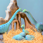 Bumbu Big Wooden Brontosaurus pictured next to the baby brontosaurus on a window sill