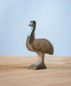 A Bumbu wooden male emu figure standing on a wooden board