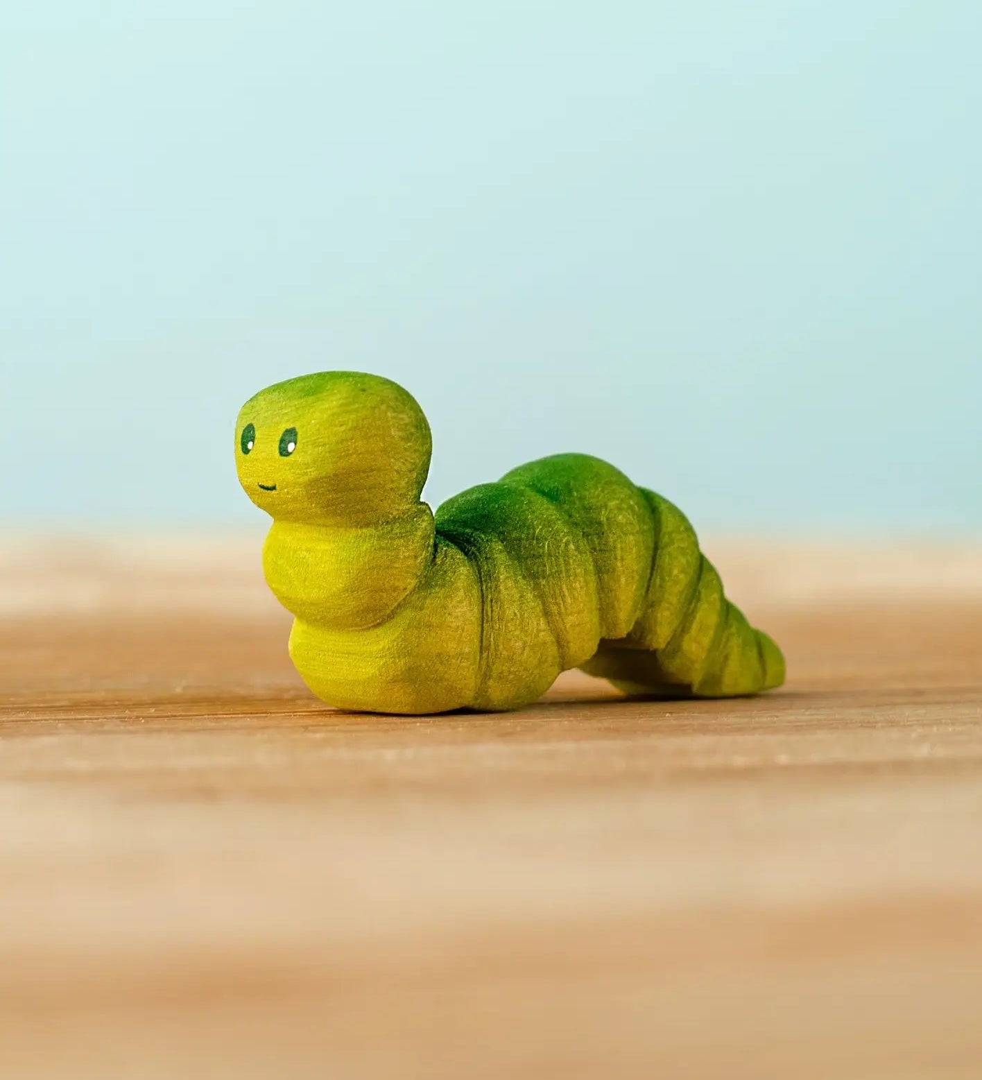 Bumbu handcrafted wooden green caterpillar figure with painted facial features