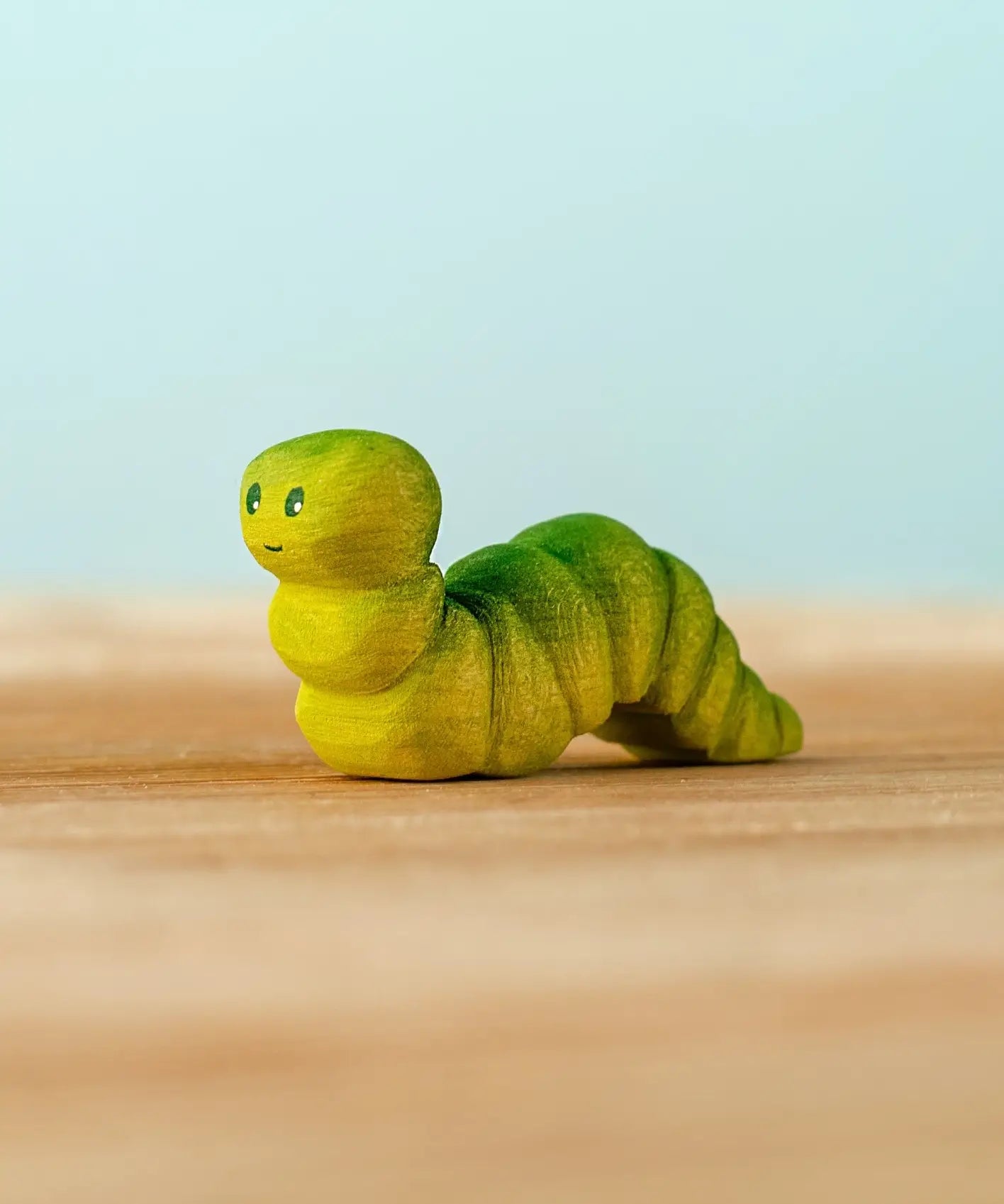 Bumbu handcrafted wooden green caterpillar figure with painted facial features