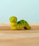 Bumbu handcrafted wooden green caterpillar figure with painted facial features
