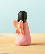 Back of the Bumbu handcrafted wooden cherry fairy figure with painted black hair and wings