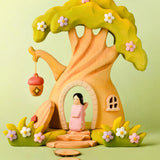 Bumbu handcrafted wooden cherry fairy figure standing in the fairy treehouse doorway