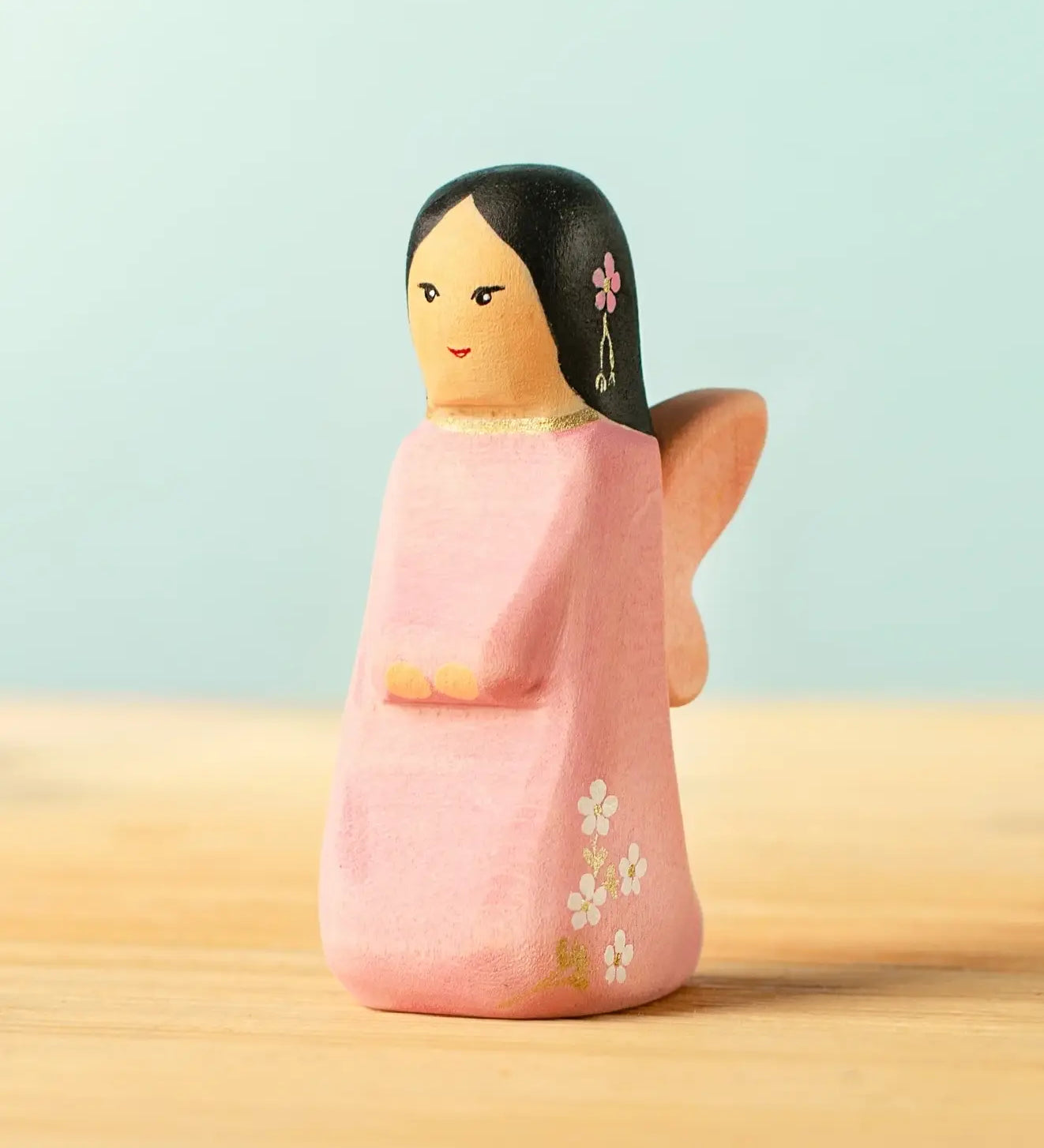 Bumbu handcrafted wooden cherry fairy figure with painted black hair, flowers and facial features