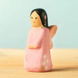 Bumbu handcrafted wooden cherry fairy figure with painted black hair, flowers and facial features