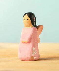 Bumbu handcrafted wooden cherry fairy figure with painted black hair, flowers and facial features