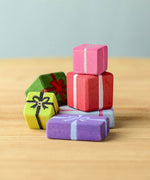 A set of wooden Bumbu presents, all different sized and colours including, yellow, green, purple, red and pink.