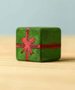 A dark green wooden Bumbu Christmas present.