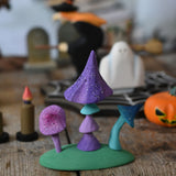 A set of Bumbu enchanted mushrooms placed at the front of a halloween small world play scene. These expertly hand crafted items are part of a large range of wooden toys available here at Babipur. 