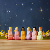 A nighttime display showing all Bumbu wooden fairy figures and blossom bushes