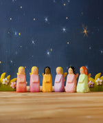 A nighttime display showing all Bumbu wooden fairy figures and blossom bushes