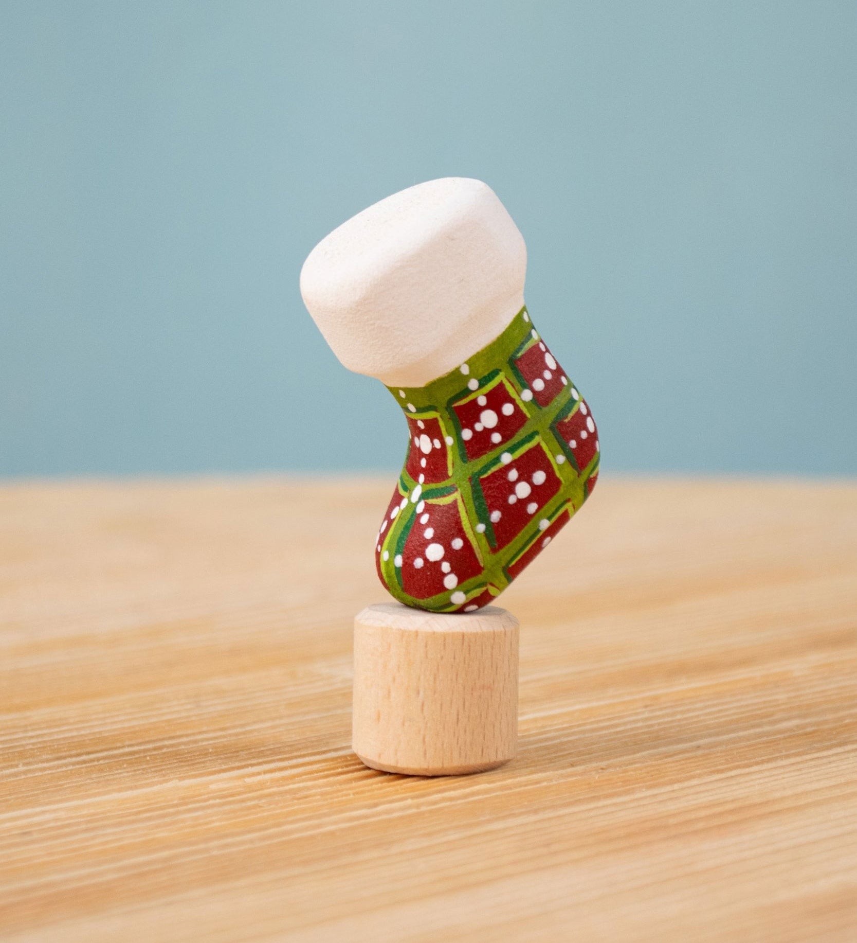 Bumbu red and green Festive Christmas Stocking Celebration decorative Figure to fit on a Grimm's celebration ring. These festive figures are perfect for your Christmas celebration ring set up. These expertly hand crafted items are part of a large range of wooden toys available here at Babipur. 