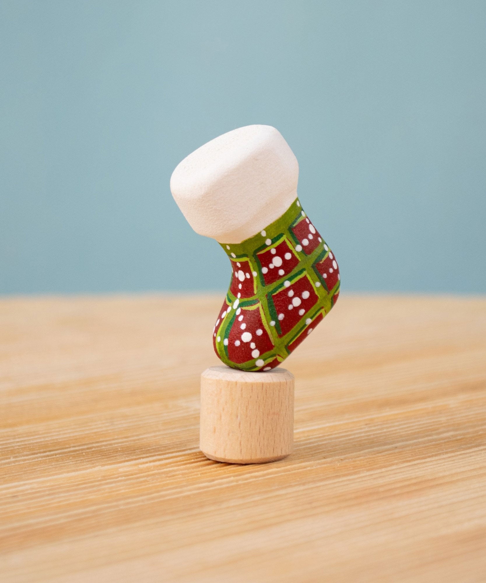 Bumbu red and green Festive Christmas Stocking Celebration decorative Figure to fit on a Grimm's celebration ring. These festive figures are perfect for your Christmas celebration ring set up. These expertly hand crafted items are part of a large range of wooden toys available here at Babipur. 