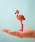 Bumbu toys handcrafted wooden pink standing flamingo figure in a hand showing scale