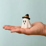 Bumbu wooden ghost wizard decorative figure standing on a adult hand showing scale 