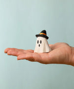 Bumbu wooden ghost wizard decorative figure standing on a adult hand showing scale 