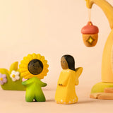 Bumbu wooden golden fairy figure standing next to a daisy flower child figure