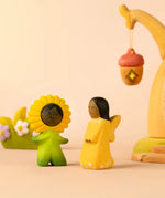 Bumbu wooden golden fairy figure standing next to a daisy flower child figure