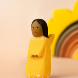 Bumbu wooden golden fairy figure with a sun stacker in the background.