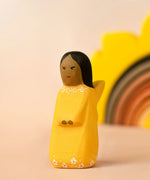 Bumbu wooden golden fairy figure with a sun stacker in the background.