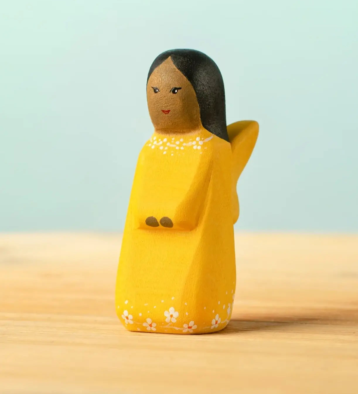 Bumbu handcrafted wooden golden fairy figure with painted black hair, flowers and facial features