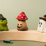 Bumbu handcrafted wooden enchanted mushroom decorative figure displayed on a celebration ring between a spell frog and ghost wizard figure