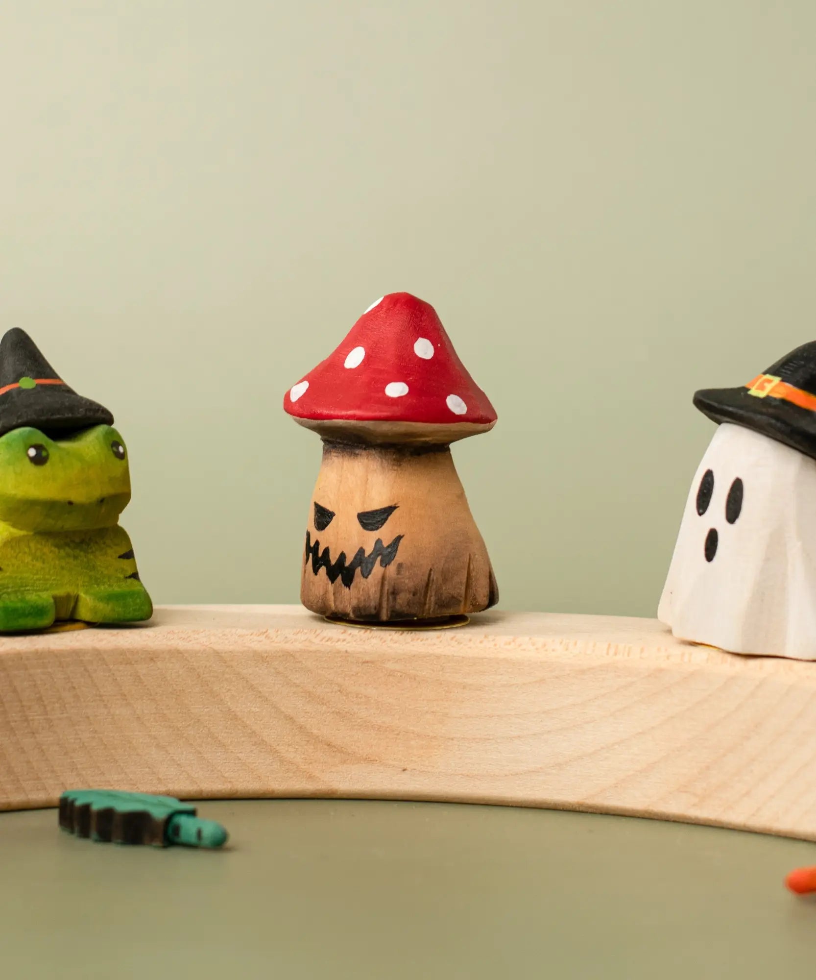 Bumbu handcrafted wooden enchanted mushroom decorative figure displayed on a celebration ring between a spell frog and ghost wizard figure
