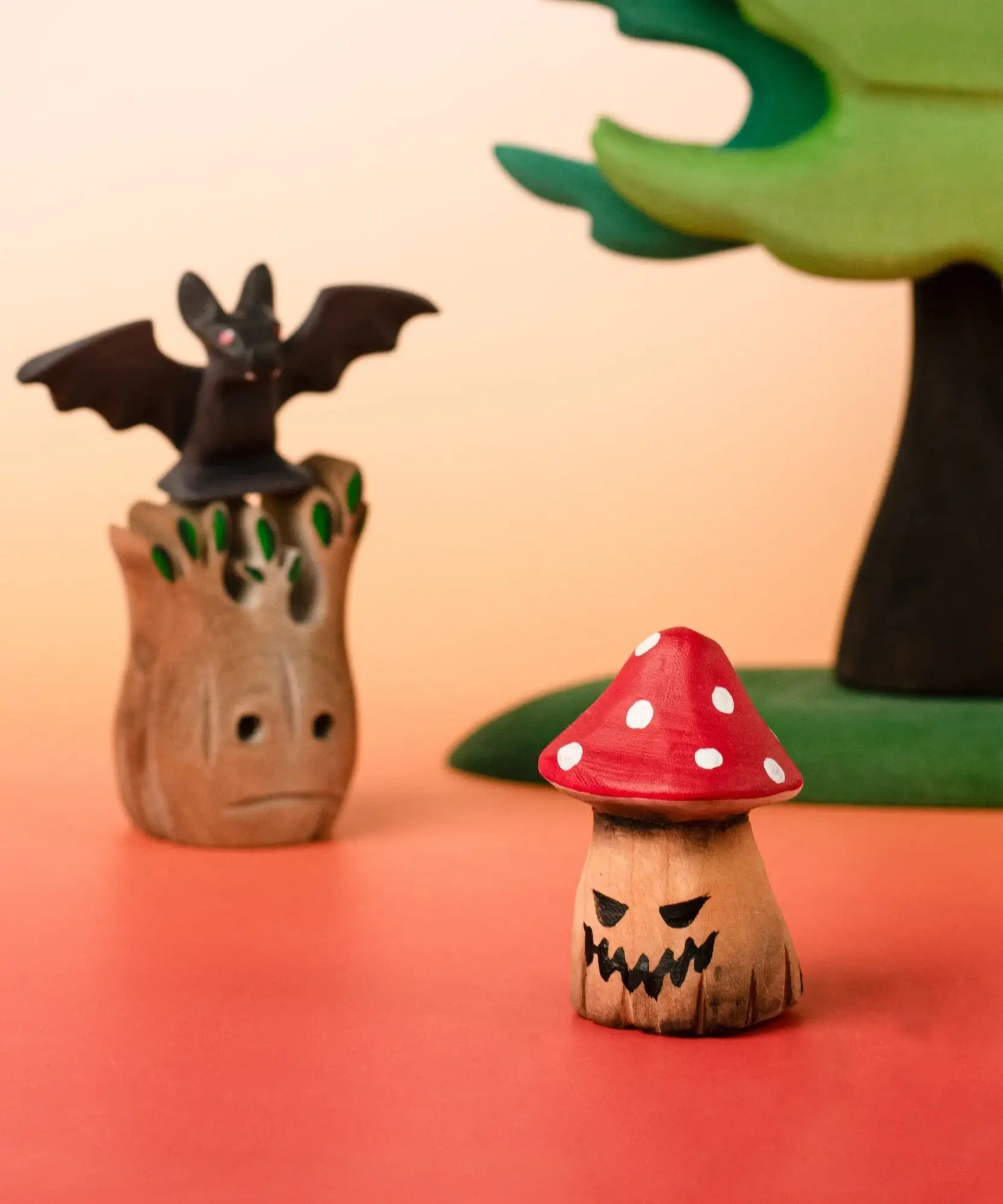 Bumbu handcrafted wooden enchanted mushroom decorative figure in a halloween display including a small spooky tree and a bat figure
