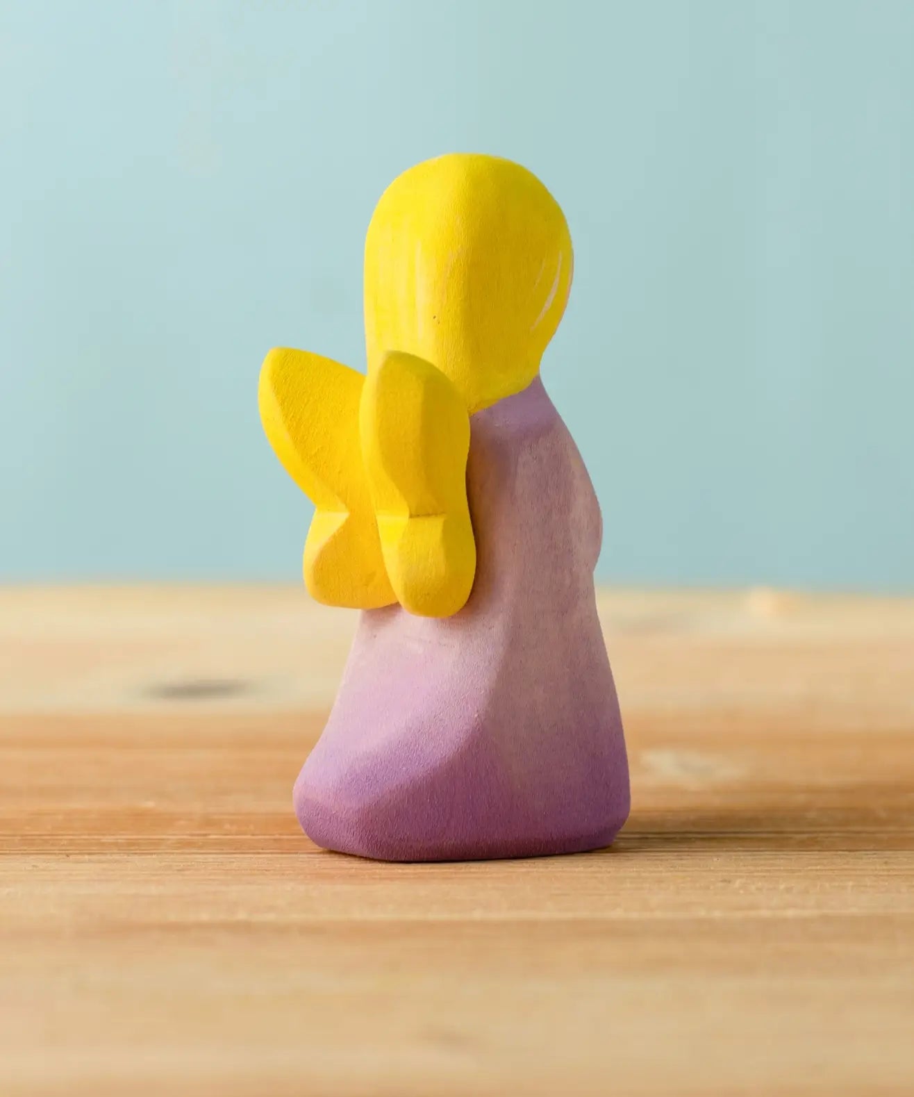 Back of Bumbu handcrafted wooden lavender fairy figure showing the yellow wings detail