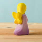 Back of Bumbu handcrafted wooden lavender fairy figure showing the yellow wings detail