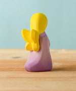 Back of Bumbu handcrafted wooden lavender fairy figure showing the yellow wings detail