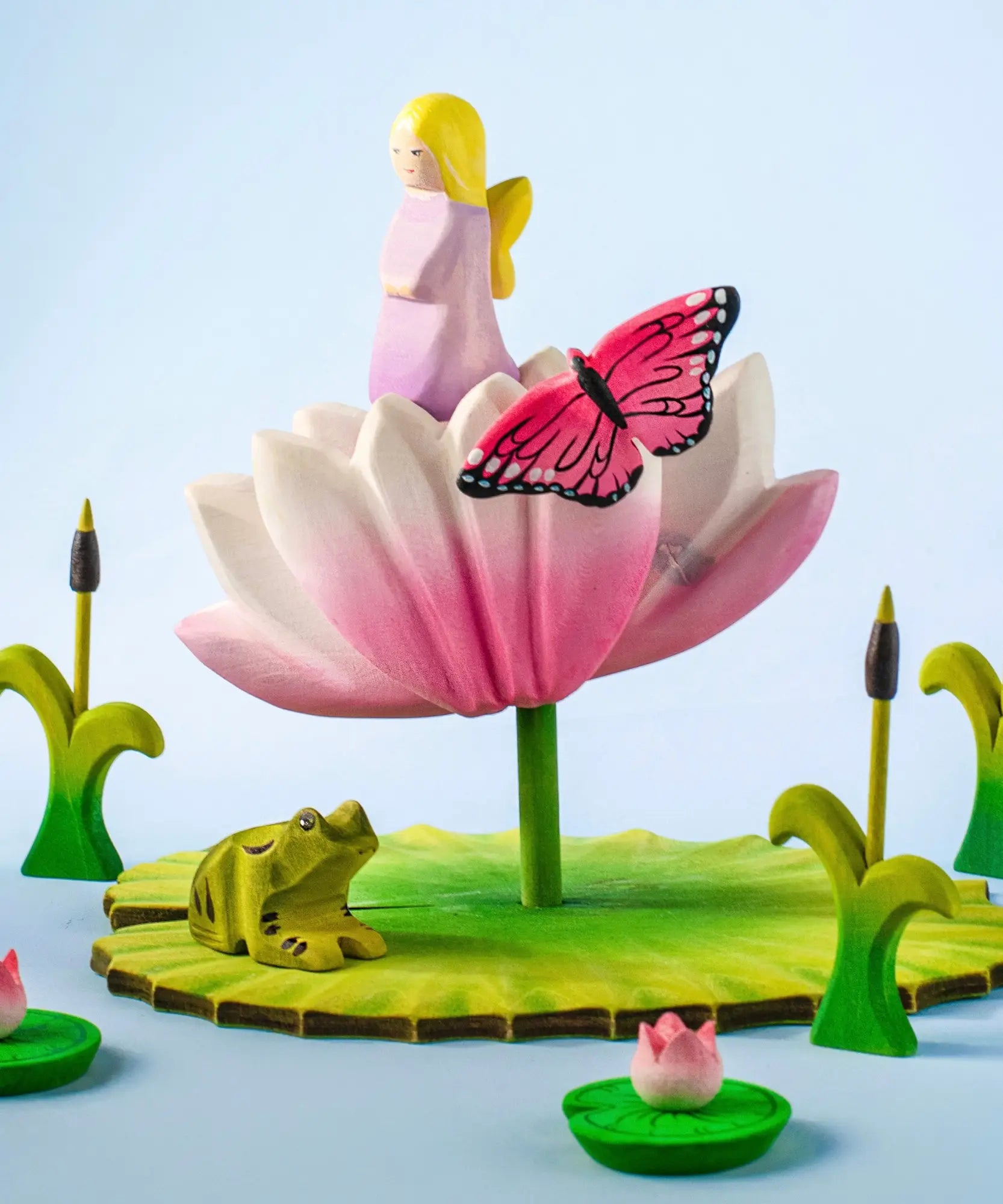 A pond playscene showing a Bumbu lavender fairy figure, frog, butterfly, lily and lotus flower figures