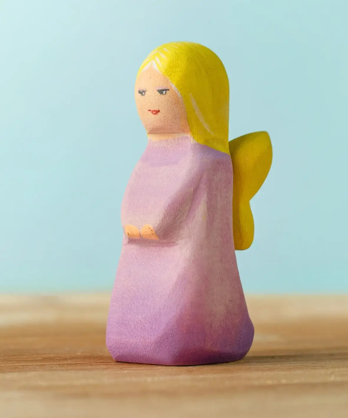 Bumbu handcrafted wooden lavender fairy figure with painted yellow hair, wings and facial features